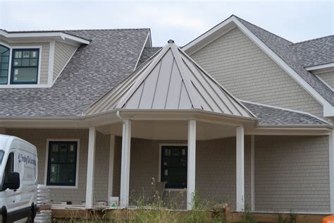 white house with a champange metal roof|white house with metal roof.